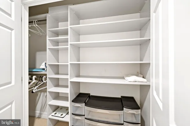 a bedroom with a bed and a large mirror