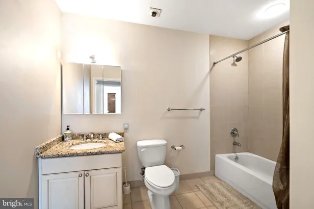 a bathroom with a shower a sink and a toilet