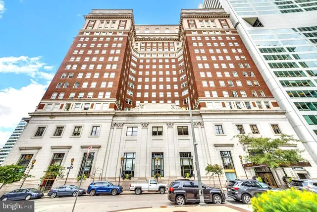 a living room with lots of furniture and chandelier