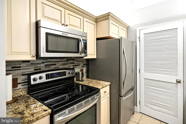 a kitchen with wooden cabinets and a stove top oven