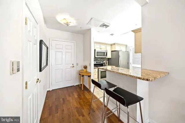 a very nice looking room with a large window and wooden floor