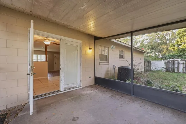 a view of a house with a big yard and large trees