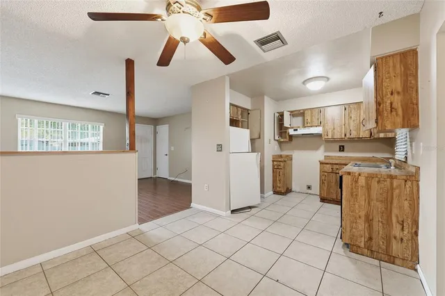 a kitchen with stainless steel appliances granite countertop a refrigerator and a stove