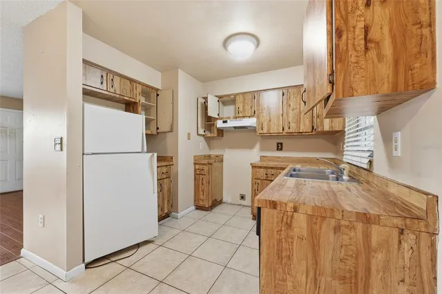 a kitchen with a stove sink and cabinets