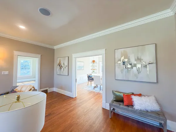 a living room with fireplace furniture and a wooden floor