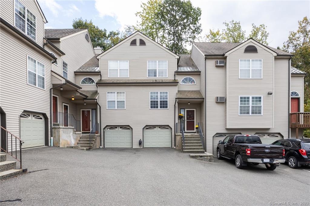 7 Taft Pointe, Unit 57 Waterbury, CT 06708 - Photo 1 of 1 a car parked in front of a house