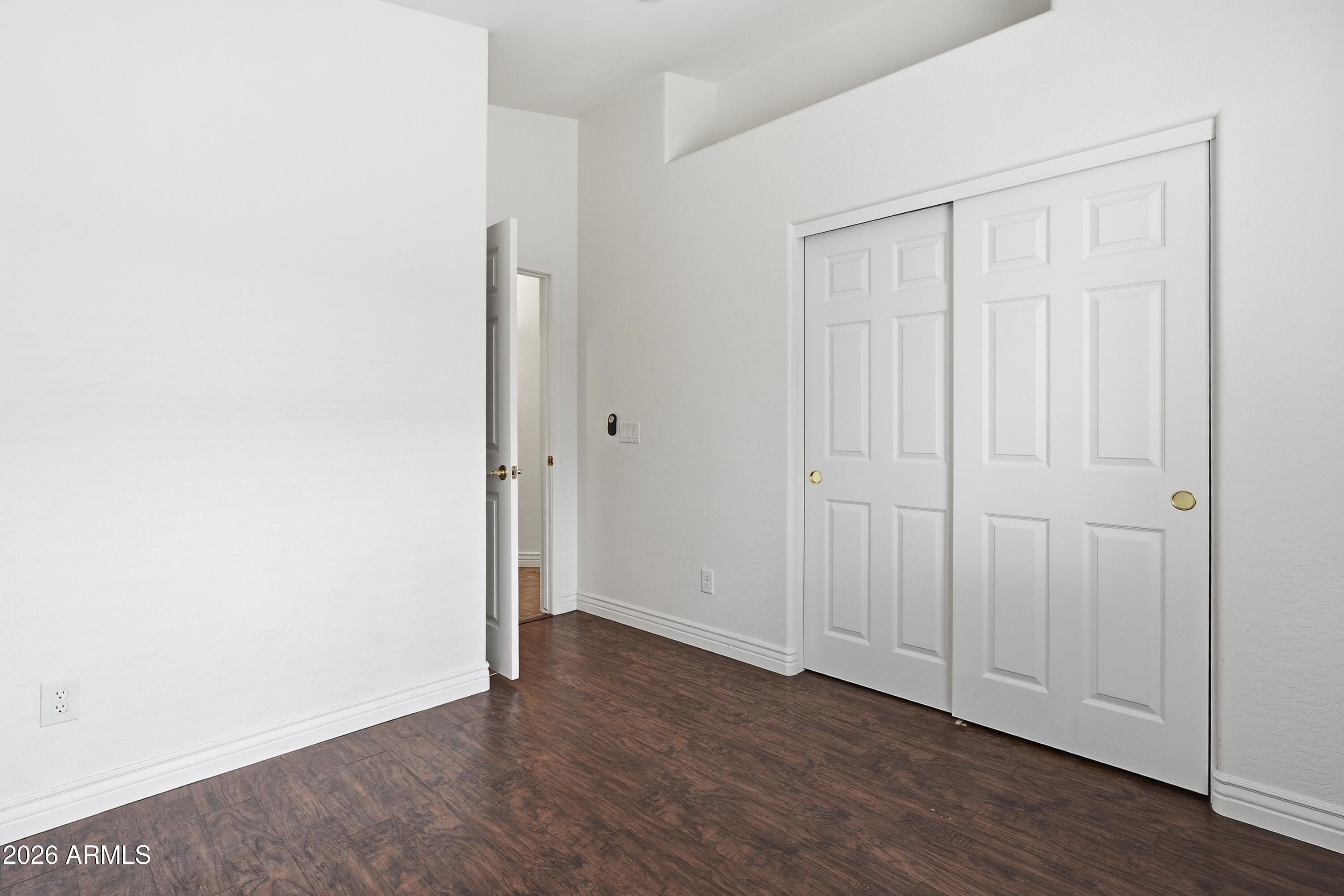 3242 East Bonanza Road Gilbert, AZ 85297 - Photo 18 of 36 an empty room with wooden floor and closet area