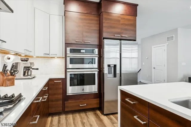 a kitchen with stainless steel appliances a stove and a refrigerator