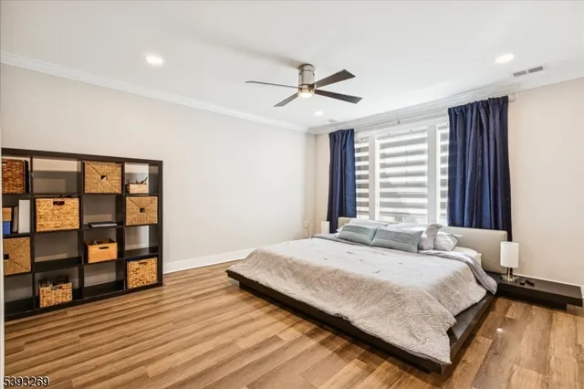 a bedroom with a bed a dresser and a window