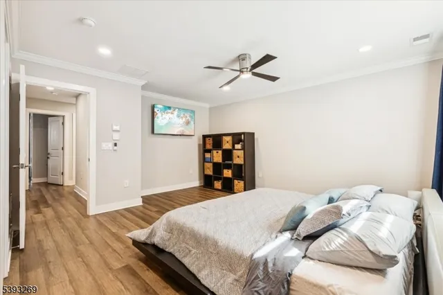 a bedroom with a large bed and a wooden floor