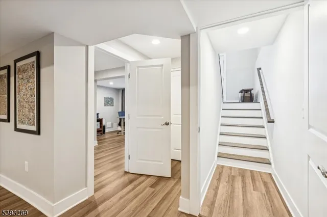 a view of a hallway with wooden floor and entryway