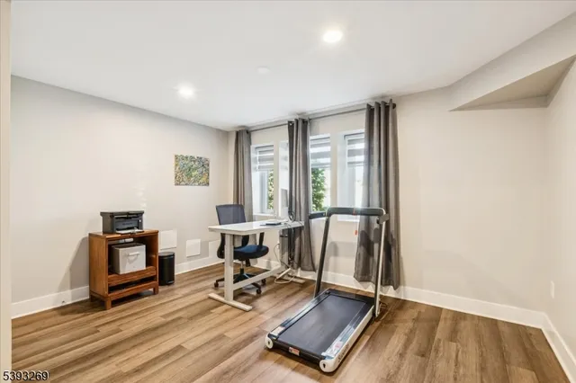 a view of a workspace with furniture and a window