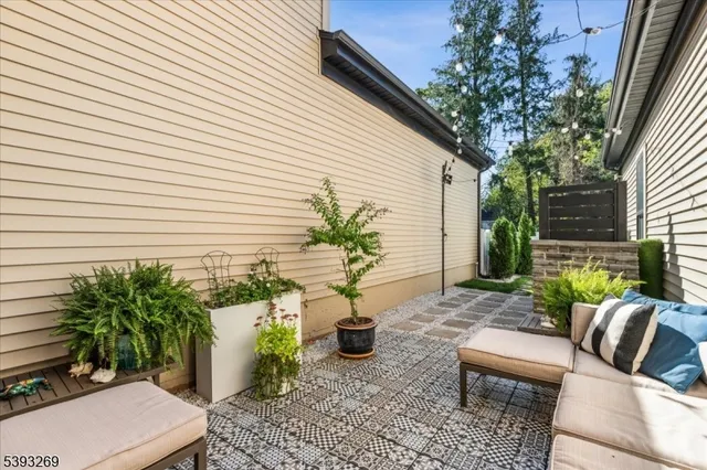 a view of a patio with chairs and potted plants