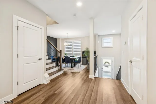 a view of a livingroom with wooden floor and furniture