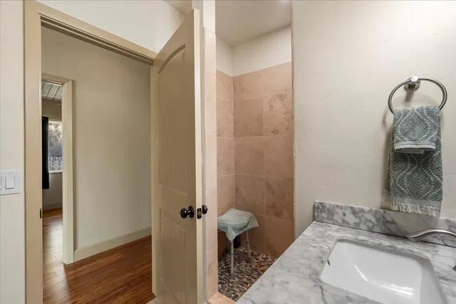 a bathroom with a sink a toilet and shower