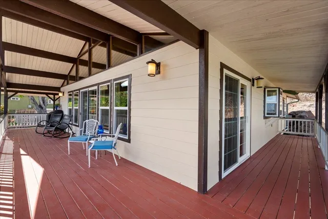 a view of a patio with table and chairs and wooden floor