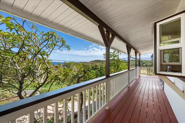 a view of a balcony with wooden floor