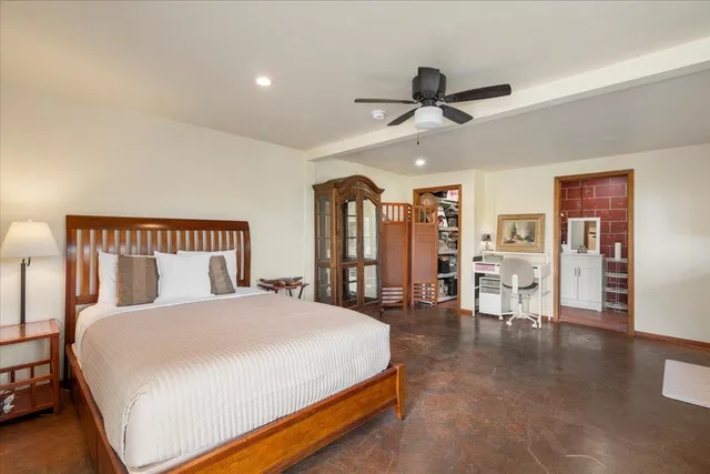 a spacious bedroom with a bed and a large mirror