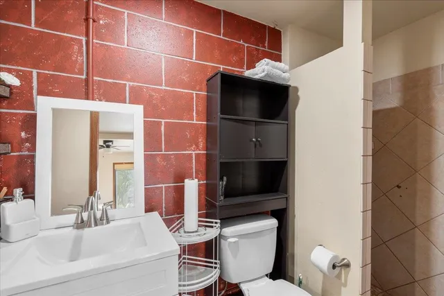 a bathroom with a toilet a sink and a mirror