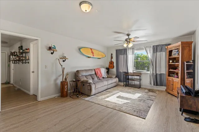 a living room with furniture window and a flat screen tv
