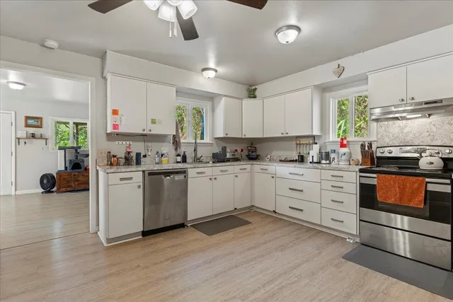 a kitchen with stainless steel appliances a refrigerator sink and cabinets