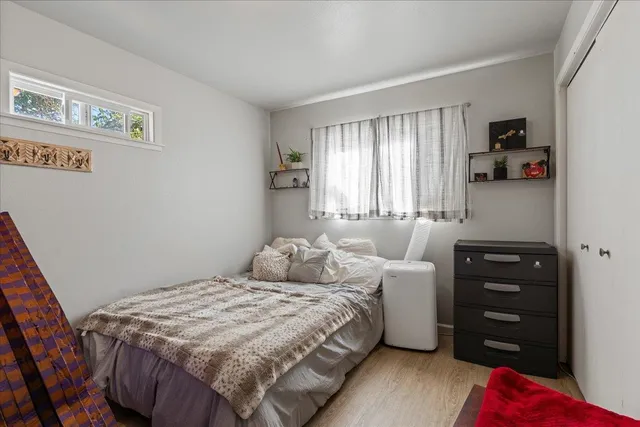 a view of a forest with mountains in the background