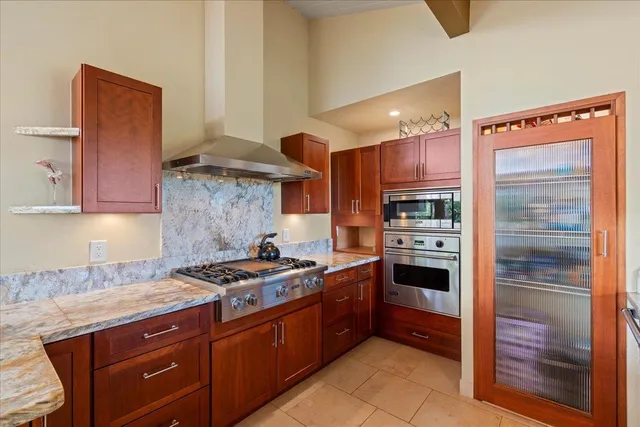 a kitchen with stainless steel appliances granite countertop a stove and a refrigerator