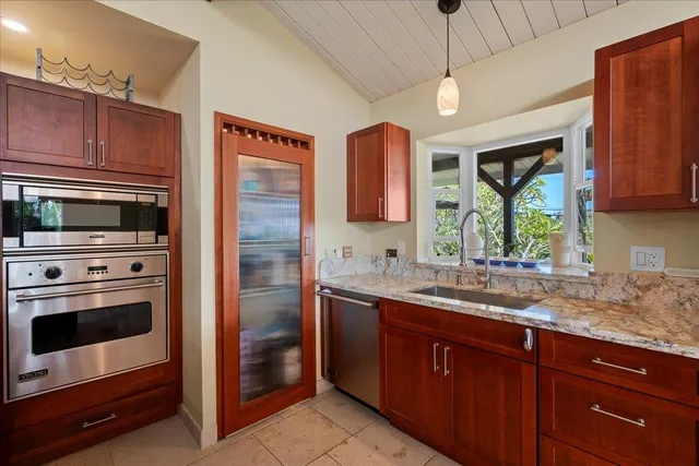 a kitchen with a sink stove and microwave