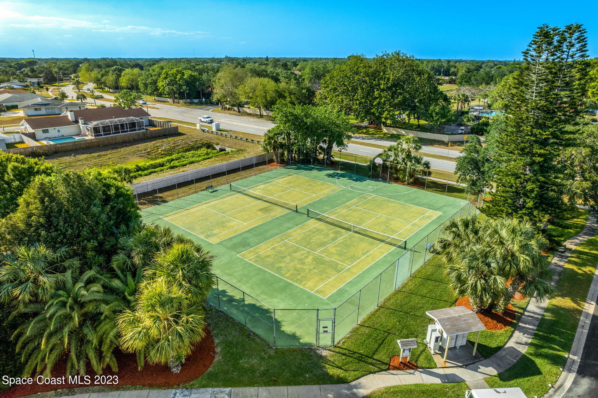 609 Cedar Side Circle Northeast Palm Bay, FL 32905 - Photo 16 of 19 a view of a tennis ground with large trees