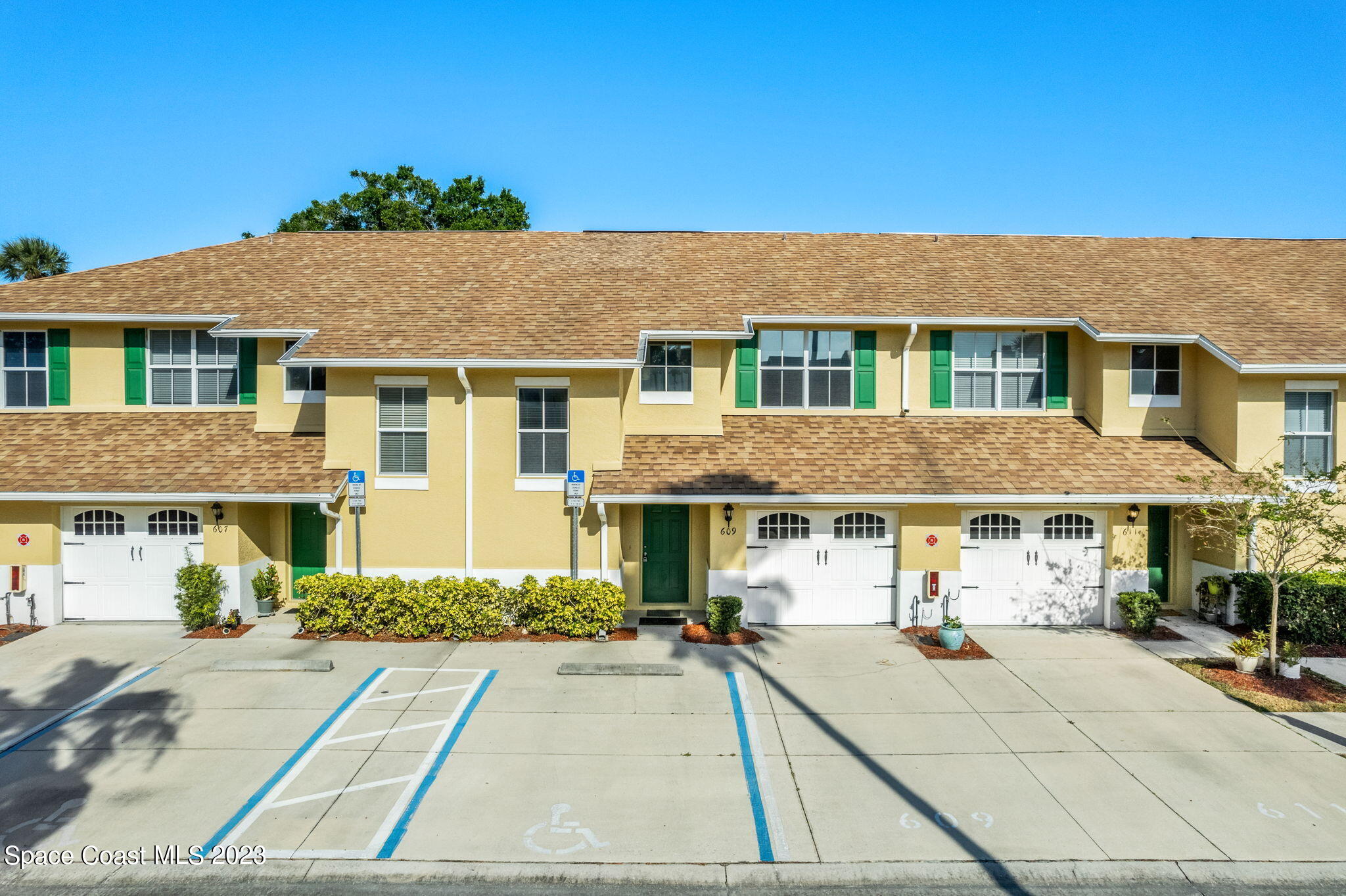 609 Cedar Side Circle Northeast Palm Bay, FL 32905 - Photo 18 of 19 a front view of a house with a yard