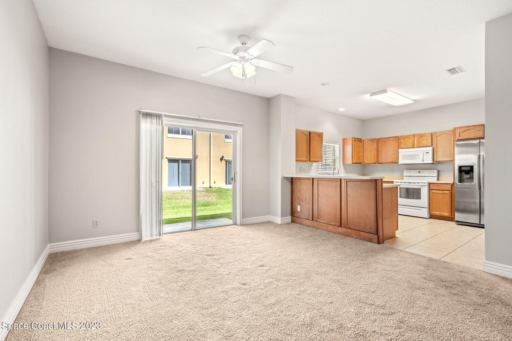 609 Cedar Side Circle Northeast Palm Bay, FL 32905 - Photo 3 of 19 a view of a kitchen with furniture and a window