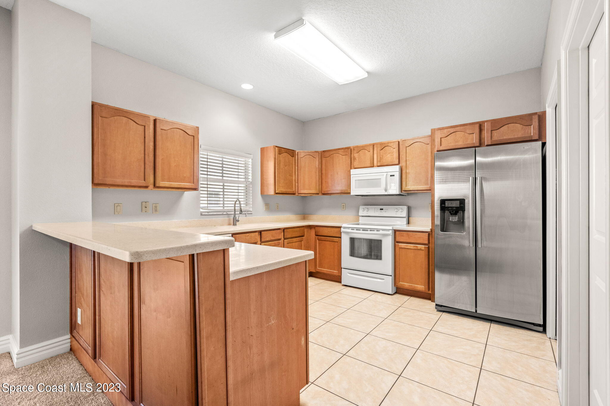 609 Cedar Side Circle Northeast Palm Bay, FL 32905 - Photo 4 of 19 a kitchen with stainless steel appliances granite countertop a refrigerator sink and cabinets