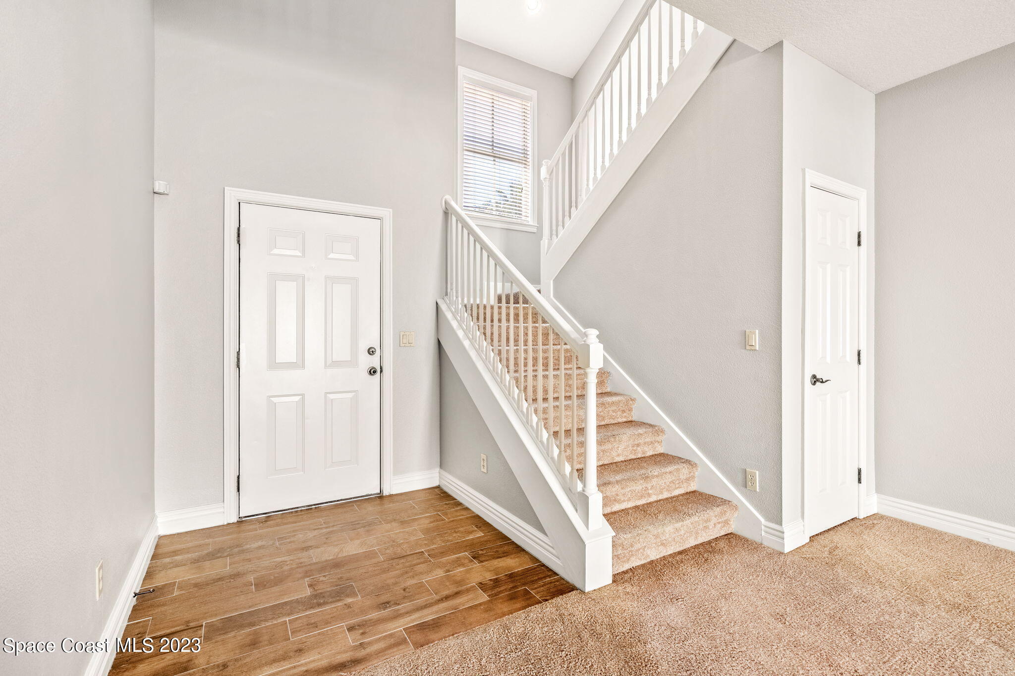 609 Cedar Side Circle Northeast Palm Bay, FL 32905 - Photo 6 of 19 a view of staircase with white walls and white walls