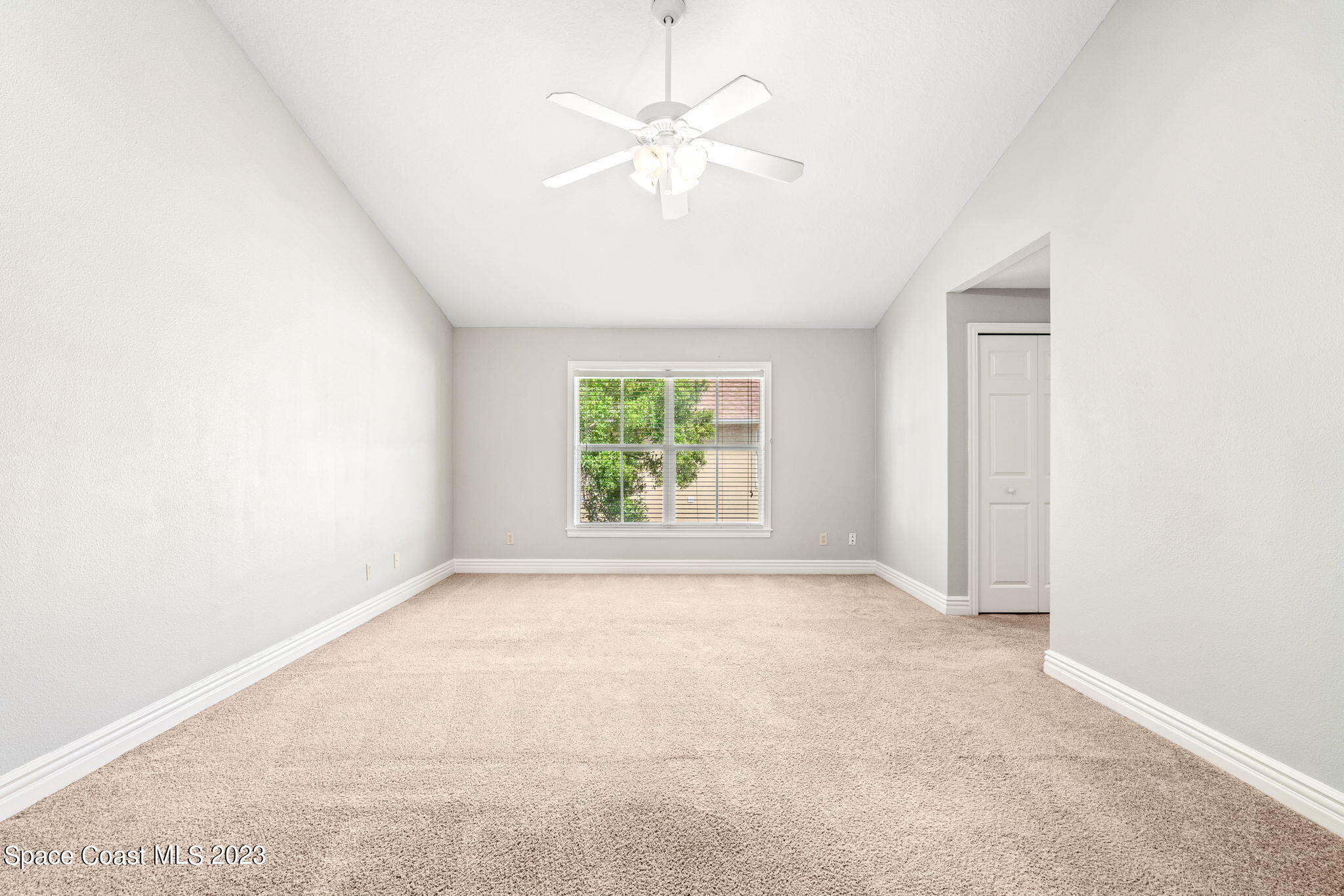 609 Cedar Side Circle Northeast Palm Bay, FL 32905 - Photo 8 of 19 an empty room with a window and a fan