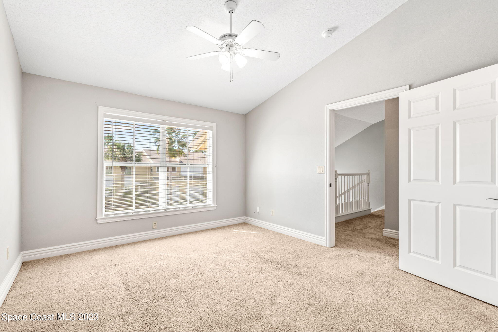 609 Cedar Side Circle Northeast Palm Bay, FL 32905 - Photo 10 of 19 an empty room with windows and fan