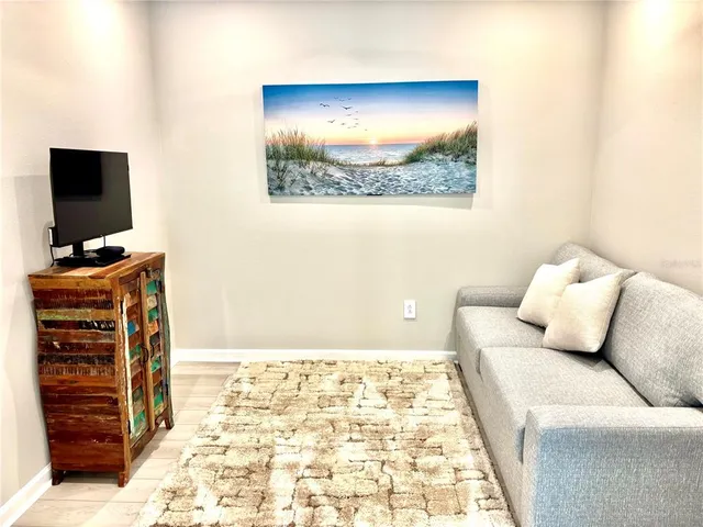 a living room with couch and a flat screen tv