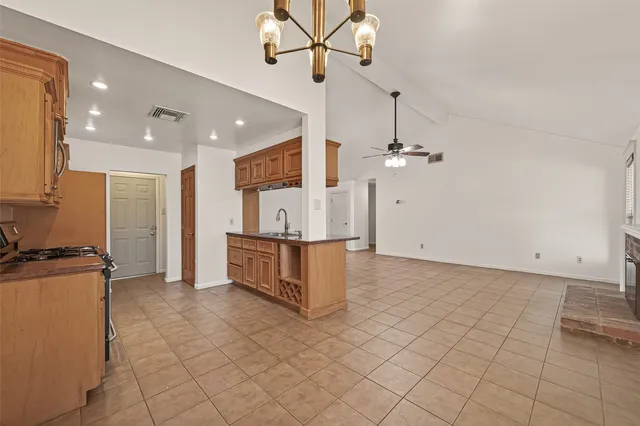 a view of kitchen with refrigerator and microwave