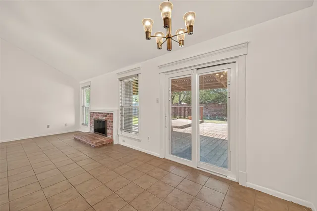 a view of an empty room with a fireplace