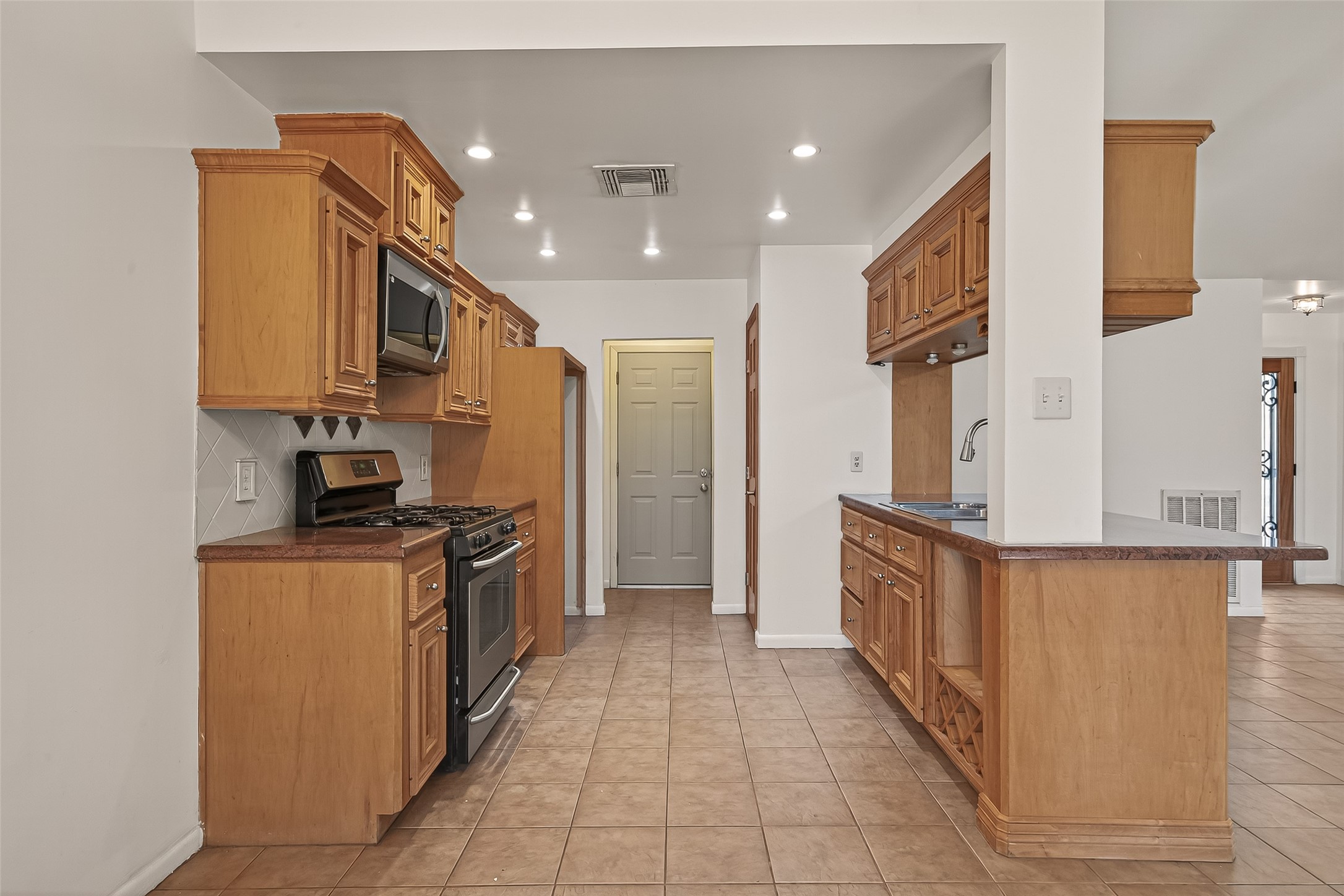 2510 Old Fort Road Sugar Land, TX 77479 - Photo 17 of 41 a kitchen with stainless steel appliances granite countertop a stove a sink and a refrigerator