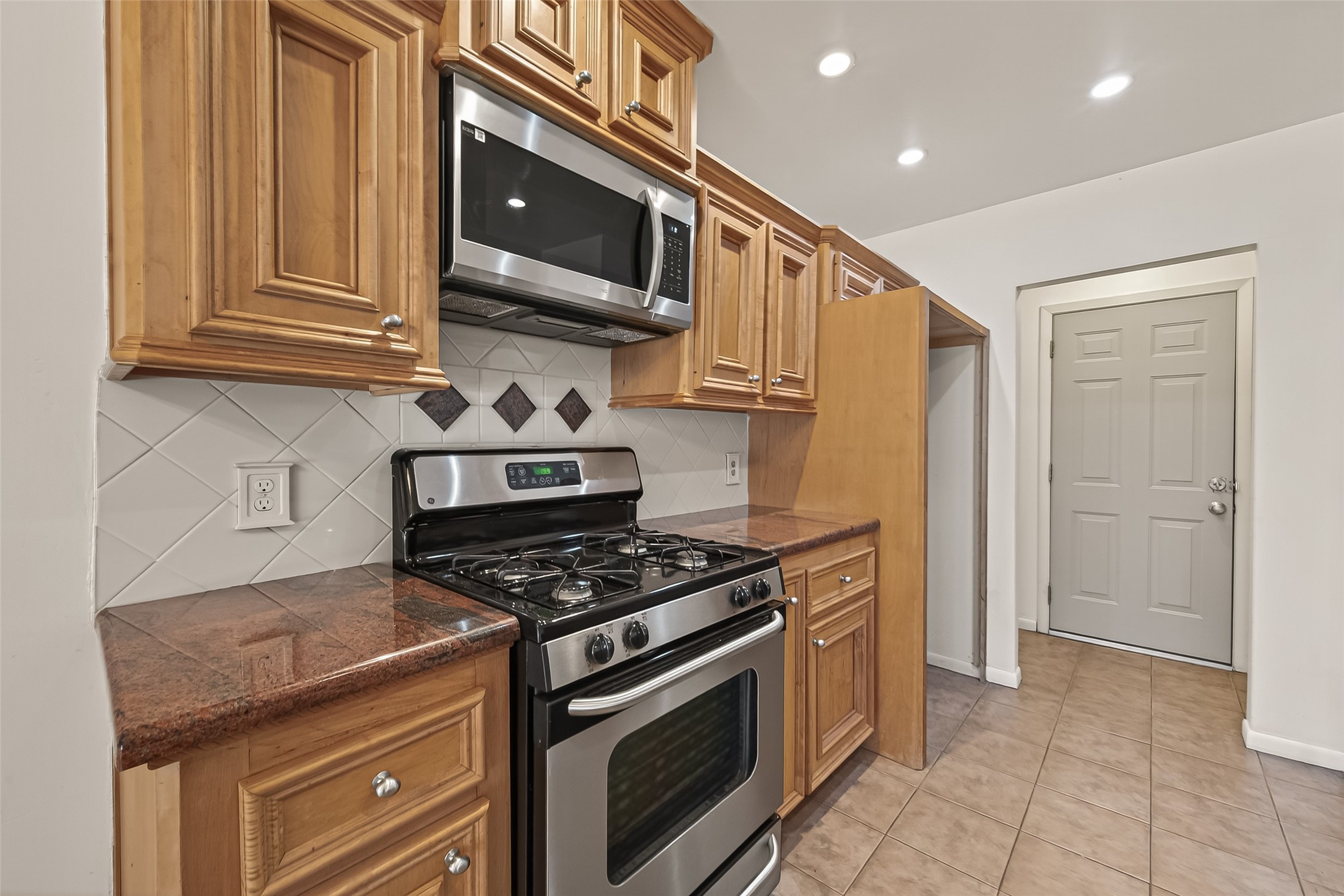 2510 Old Fort Road Sugar Land, TX 77479 - Photo 22 of 41 a kitchen with stainless steel appliances granite countertop a stove and a microwave