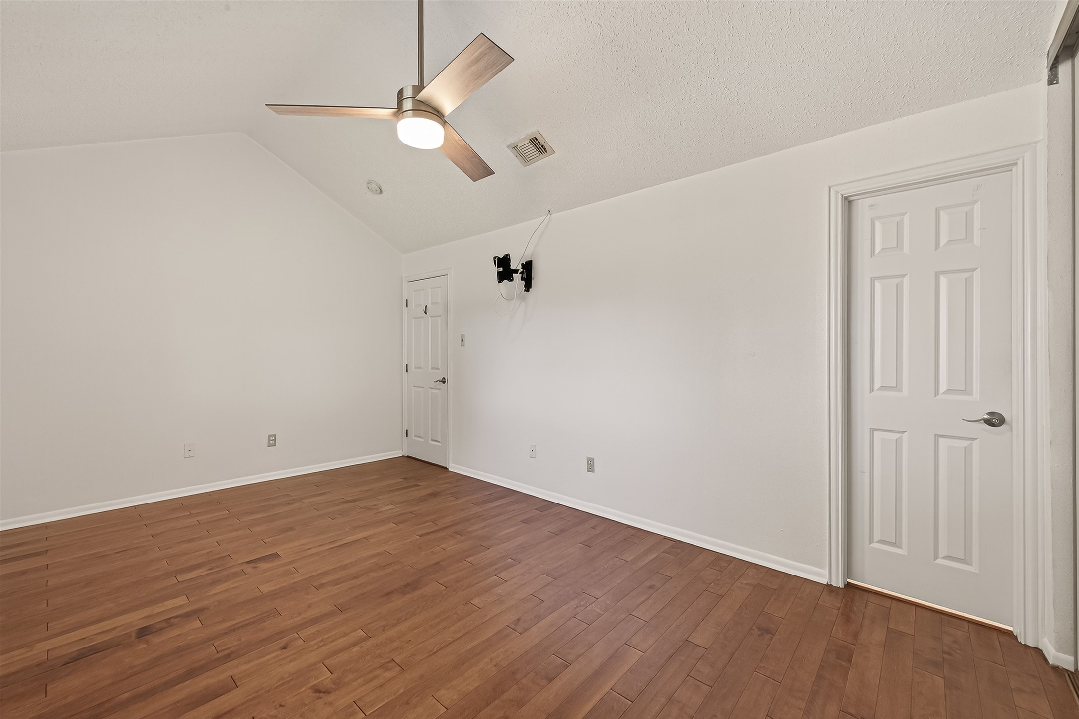 2510 Old Fort Road Sugar Land, TX 77479 - Photo 32 of 41 an empty room with wooden floor and ceiling fan