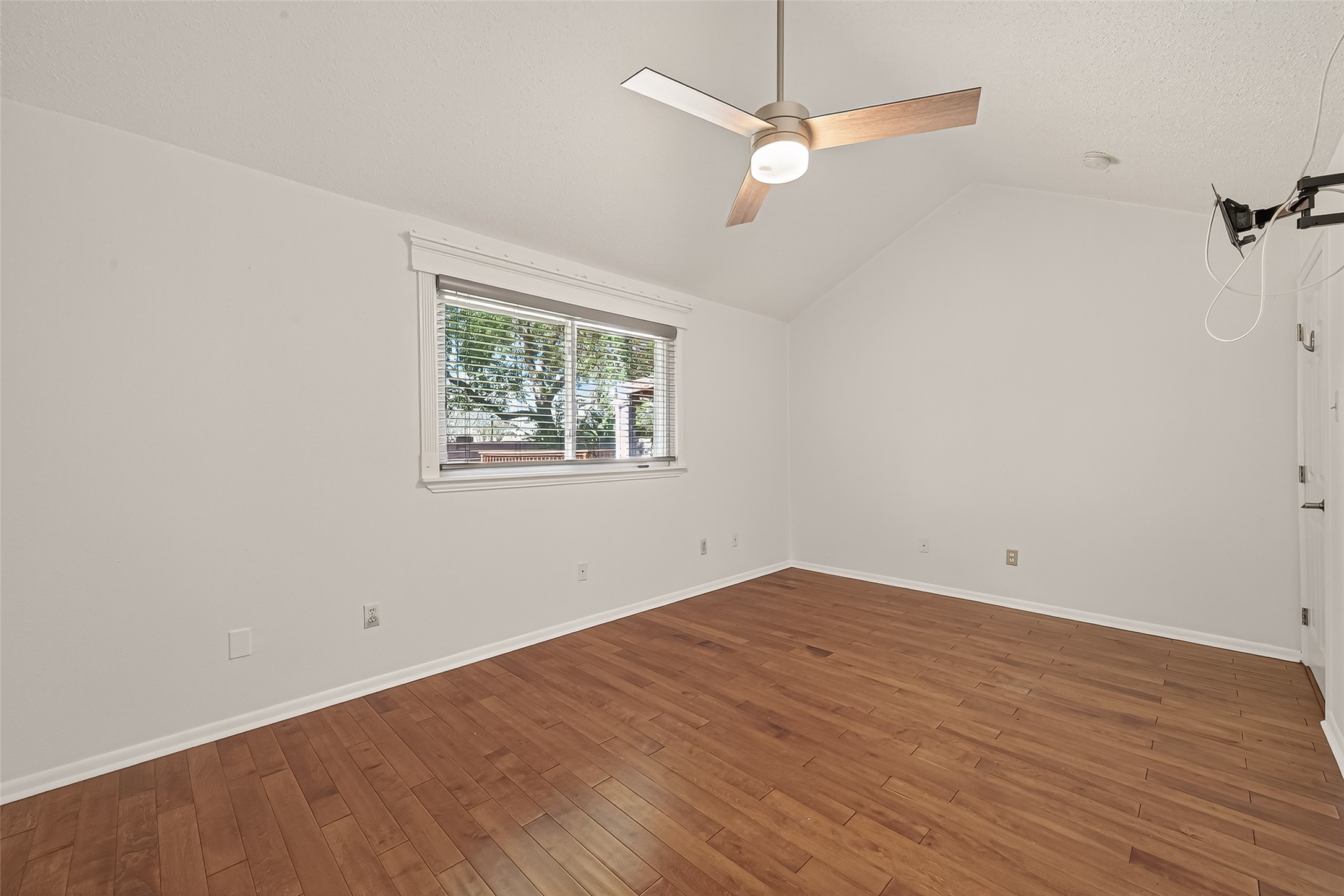2510 Old Fort Road Sugar Land, TX 77479 - Photo 33 of 41 an empty room with wooden floor ceiling fan and window