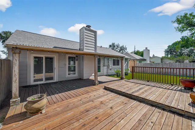 a view of a wooden deck with a yard