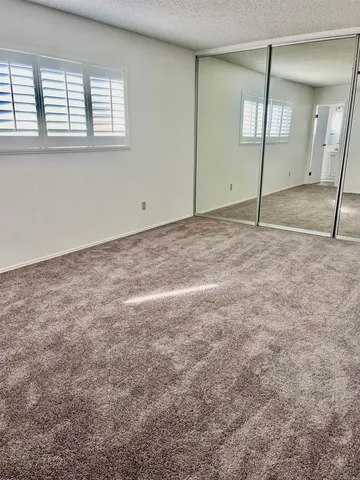a bathroom with a granite countertop toilet and a sink