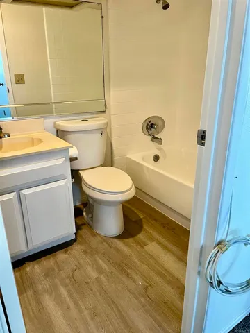 a view of kitchen and empty room with fireplace