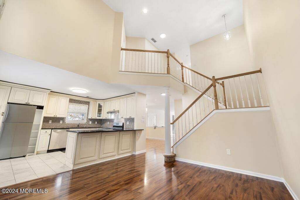 1 Painted Wagon Road Holmdel, NJ 07733 - Photo 20 of 31 20-Family Room and Stairs to Level 2