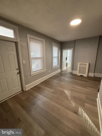 a view of empty room with window and fireplace