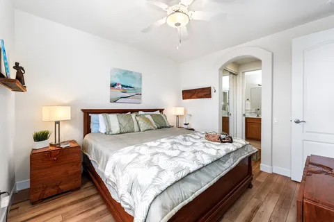 a bedroom with bed and a chandelier