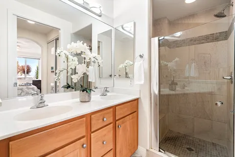 a bathroom with a shower sink and mirror