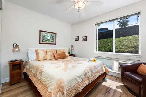 a bedroom with bed and a large window